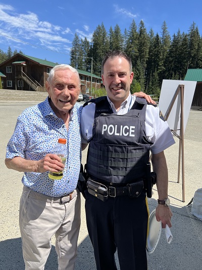 Photo of RCMP Inspector Ted Lewko standing with founder Mel Zajac