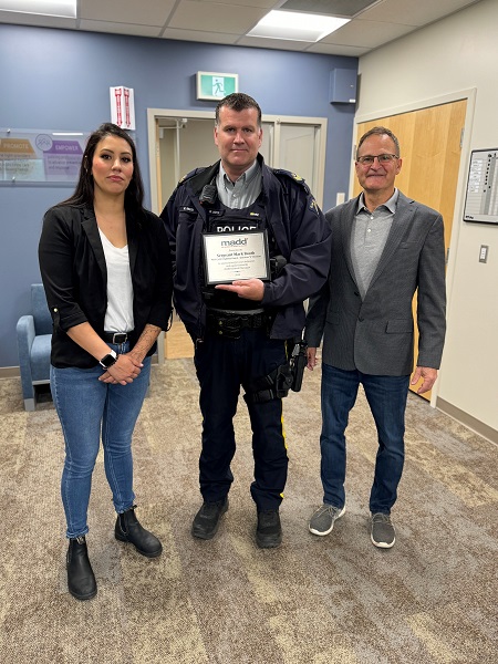 Sergeant Mark Booth with Amanda Lane and Bill Hetland 