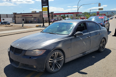 Abandoned sedan by 8th St traffic circle