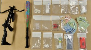 Items seized: a crossbow, a baseball bat, baggies of drugs as well as shotgun shells and Canadian cash