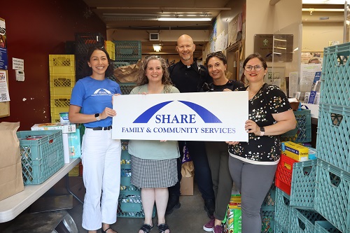 Group photo of Coquitlam RCMP officers and staff dropping off items to the SHARE Society