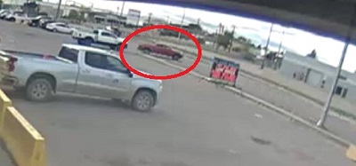A video surveillance photo of a red pickup truck turning right onto 93 Avenue