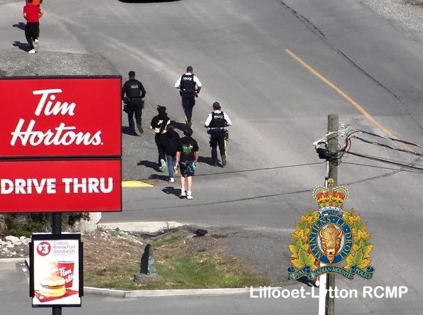 Pictured is Lillooet RCMP members and a Stl'atl'imx Tribal Police member running past a local business in full uniform in the Truth and Reconciliation Run in Lillooet.