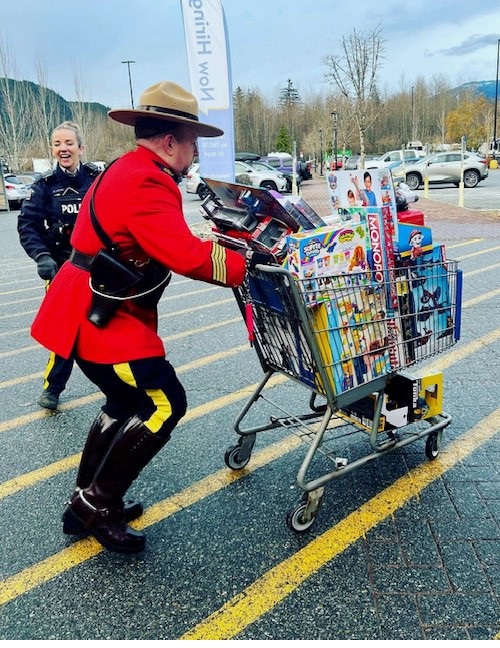 RCMP member pushing shopping cart full of donated items