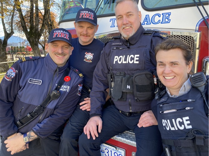 Two firefighters and two RCMP officers pose together
