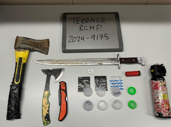 Seized axes, knives, bear spray displayed on table