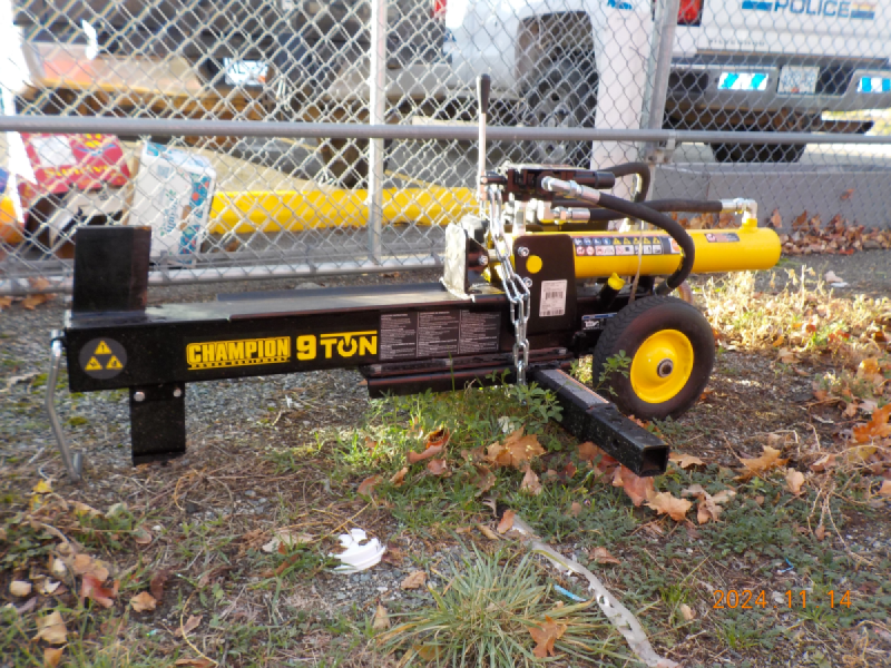 Yellow Champion 9 Ton Wood Splitter sitting on the ground in the Merritt Detachment outdoor compound.
