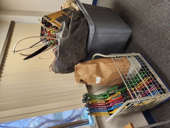 A trolley and cart of colourful bows and items recovered by police.