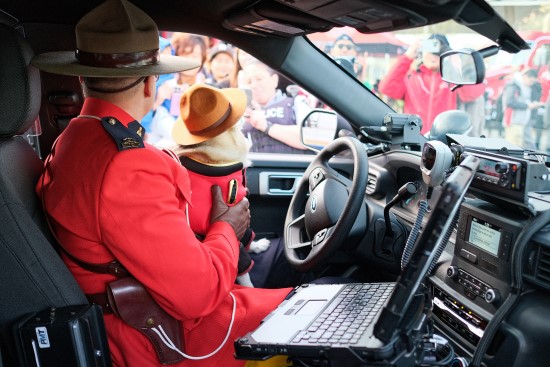Richmond RCMP officer and dog from behind sitting inside a police vehicle