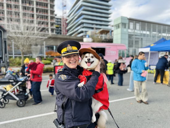 Superintendent Julie Drotar posing with dog in Mountie costume