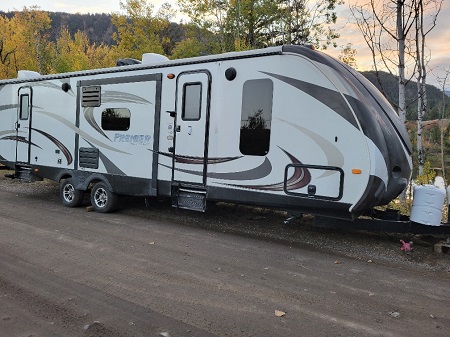 side profile photo of white travel trailer