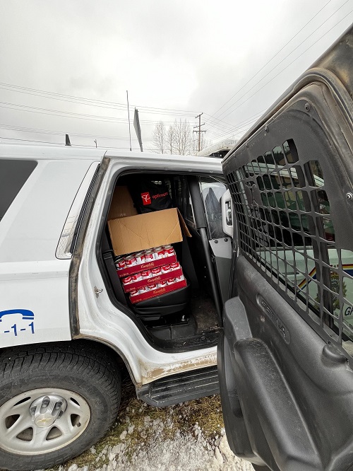 Photo of back seat of police cruiser full of items