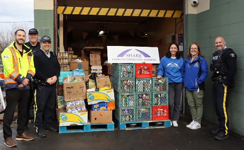 Coquitlam RCMP officers, Community policing employees and SHARE representatives dropping off donations to the SHARE Society