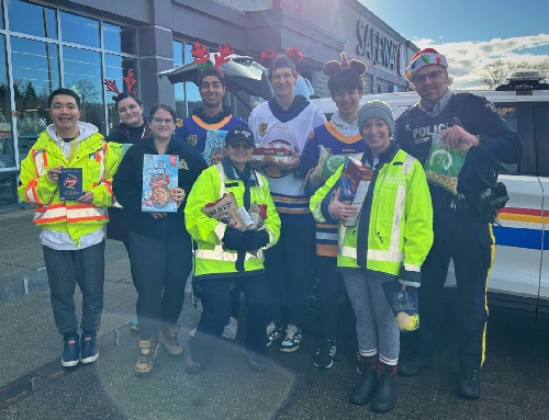  Group photo of Coquitlam RCMP Officers, staff, SHARE Society and Port Coquitlam Trail Blazer hockey players Port Coquitlam Cram the Cruiser location.