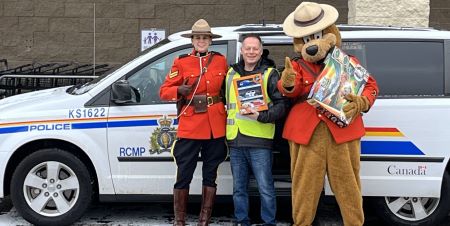The Kamloops RCMP Detachment provided a van full of toys with a special escort to Christmas Amalgamated this weekend.   On Saturday Nov. 30, 2024, the Kamloops RCMP Detachment held its annual Stuff the Cruiser toy drive in support of Christmas Amalgamated. From 10 a.m. to 3 p.m., Sergeant Safety Bear and volunteers from the Crime Prevention Unit parked their vehicles in front of the Toys R Us on Notre Dame Drive to collect unwrapped gifts and monetary donations for local children throughout the city. In total, the event is estimated to have brought in more than $365 in cash and 2,200 items for distribution in holiday hampers to kids and teens. <q>It was wonderful to see so much generosity from the people in the city who helped collect gifts for Christmas Amalgamated,</q> said Corporal Dana Napier of the Kamloops RCMP Crime Prevention Unit. <q>It was incredible to see how much time and effort people contributed to help Kamloops families.</q> The event cannot happen without the support of local businesses, volunteers, and people who donate, said Sandro Piroddi, coordinator of the Kamloops RCMP Crime Prevention Unit. Anyone who would like to donate but missed Saturday&rsquo;s event, can contact Christmas Amalgamated at 250-376-0777. A Mountie in red serge stands next to an RCMP van with a man in a fluorescent safety vest and Sergeant Safety Bear. They are holding toys.