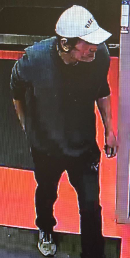 The described suspect walking through a doorway.