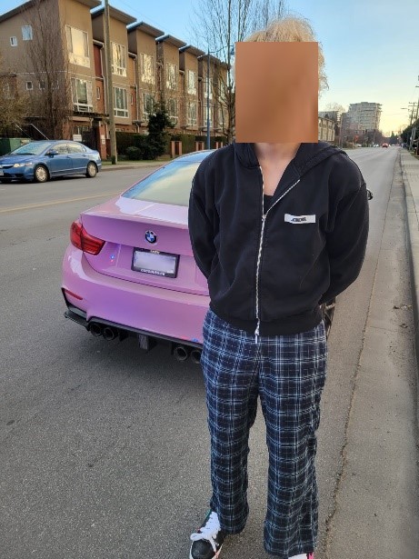 Man standing if front of a pink car
