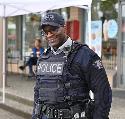 Cst. Dwight Martin stands outdoors in uniform at Hats Off Day in North Burnaby