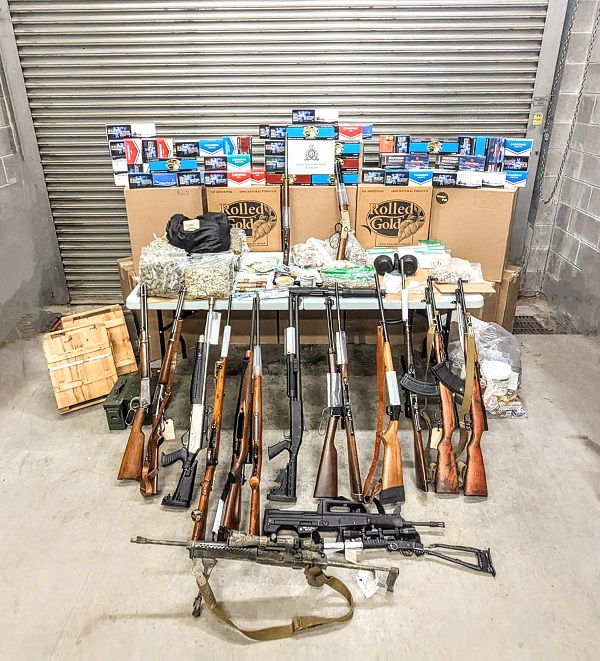 Photo of seized cigarettes, firearms, drugs and money.