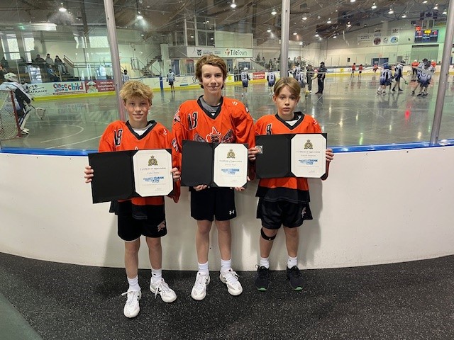 three Semiahmoo Lacrosse players displaying their RCMP certificates