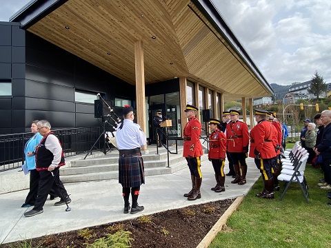 Officers in Red Serge marched towards the flagpole led by a piper