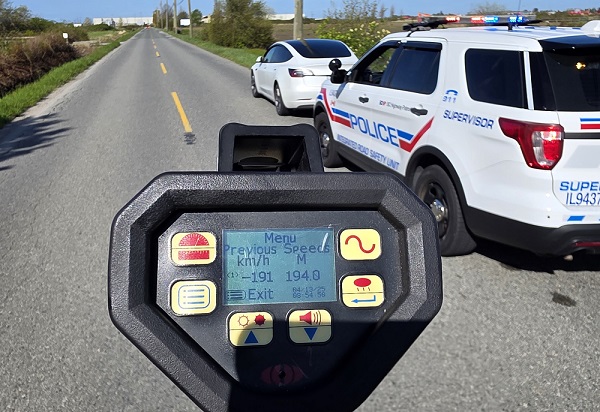 A Tesla stopped by BC Highway Patrol with a laser reader showing 191 km/h