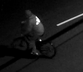 Side view of unknown individual on a bike