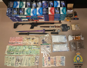 Photo of the weapons, cigarettes and illicit drugs seized from the residence 