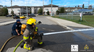 Photo of the students learning to use high-pressure fire hoses