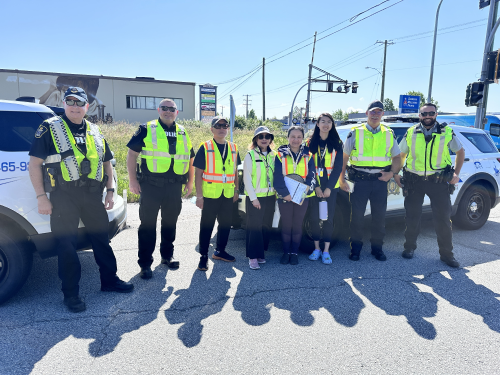 Richmond RCMP and CN Police officers standing together with community volunteers