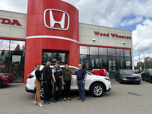 Photo of Krystal Devalud, Mike Burt, Craig Douglass, Melissa Lang and Dave Smith standing in front of the new Community Policing vehicle at Wood Wheaton Honda