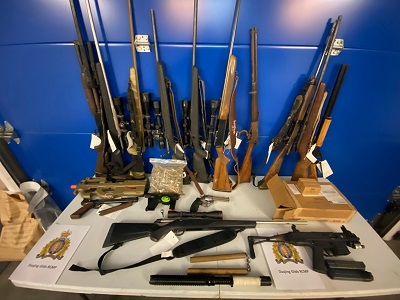 photo of items seized, guns on table