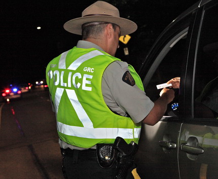 Stock photo of police officer conducting road check