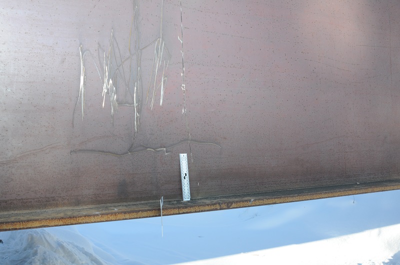 Side photo of Lamprey Creek Bridge with cut across support beam