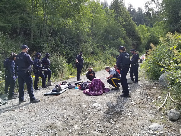 Photo of individuals in locking devices on the ground