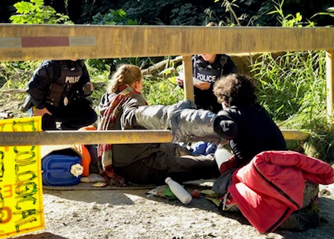 individuals in locking devices at gate