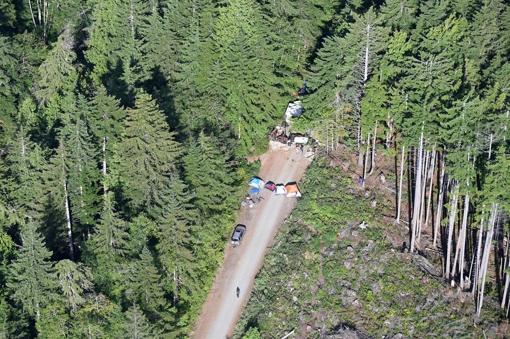 Photo of entrance to one encampment with tents blocking the road