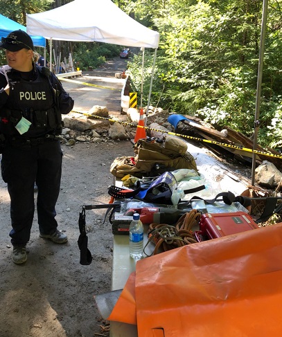 Photo of police medic near a trench of concern