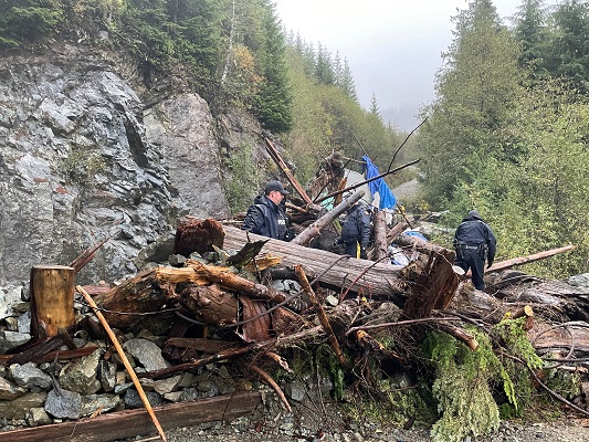 Photo of officers dismantling beaver dam like structure