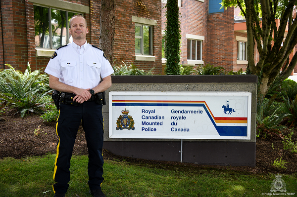 Newly promoted Inspector Martin Guay standing next to a RCMP sign outside the Ridge Meadows RCMP Detachment