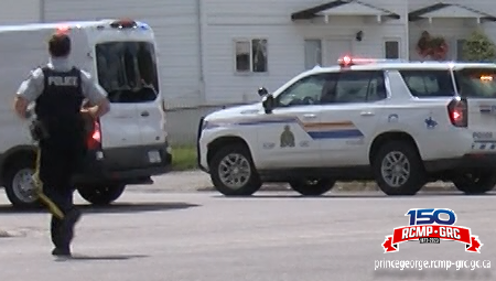 Photo of a police officer running past a police car