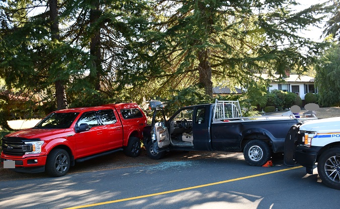 photo of  green F-250 truck crashed into a parked truck