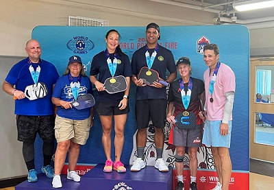 Reserve Constable Francoeur and doubles partner standing on podium with two other pickleball team winners