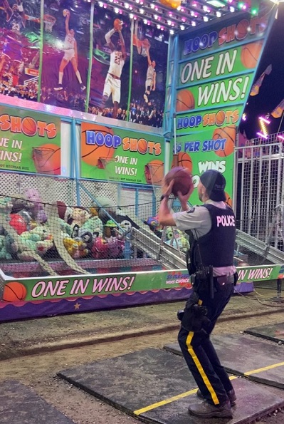 Cst. Warnes shooting basketball hoops at the IPE.