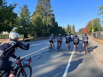 Constable Page takes a photo from her bike of 5 team members riding their bikes in front of her. 