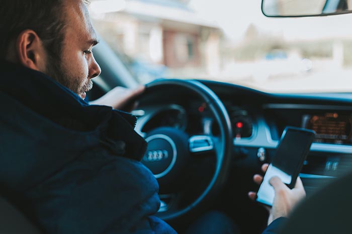 Man using cell phone while driving 