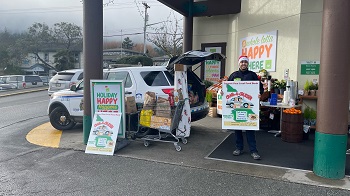 police car in front of grocery store filled with donations