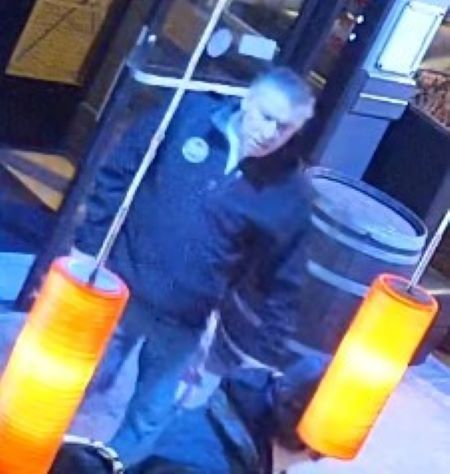 A front view of a man with grey hair in a jacket. 