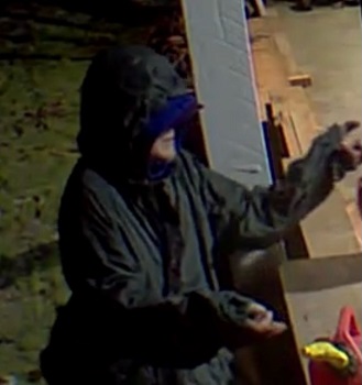 Person standing on side of garage with arms open